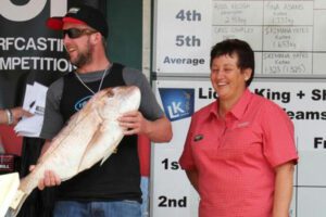 Shaun Healy with Chris from Farmlands. Shaun from Murupara won $500 for a 7.542kg fish.